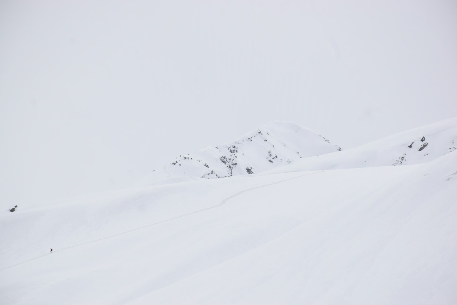 A man riding skis down a snow covered slope